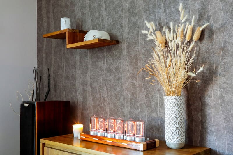 Unique Clock With Zin 70 Tubes And Wi-Fi Connectivity displayed on a wooden cabinet next to a white vase